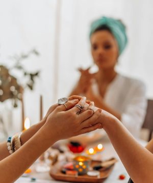 A serene indoor Reiki healing session with focus on hands, crystals, and a calming atmosphere.